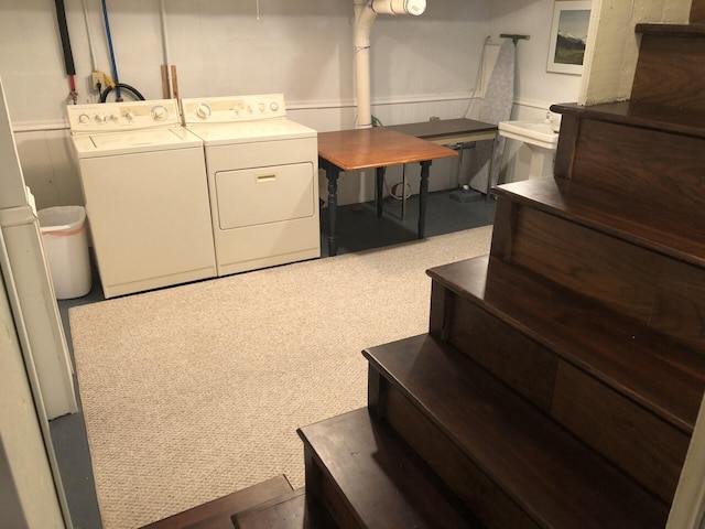 clothes washing area featuring washing machine and dryer and carpet floors