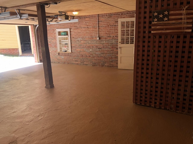 basement featuring brick wall