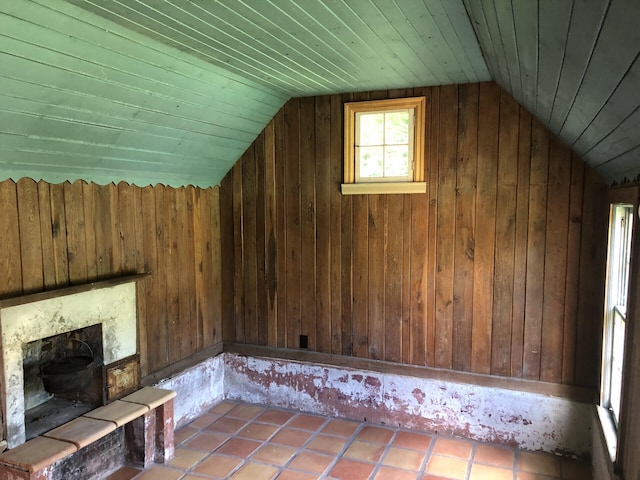 bonus room featuring tile patterned flooring, wood ceiling, lofted ceiling, and wood walls