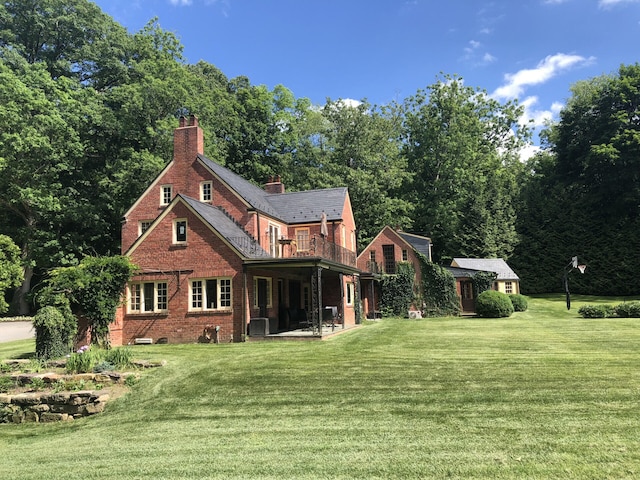 rear view of house with a yard