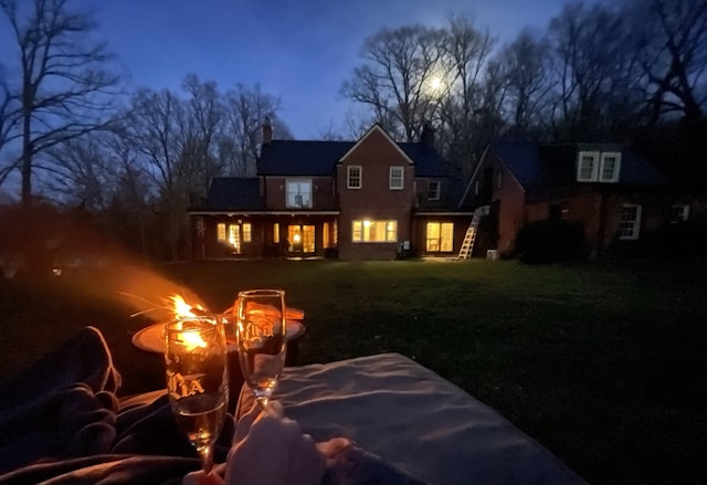 view of back house at dusk