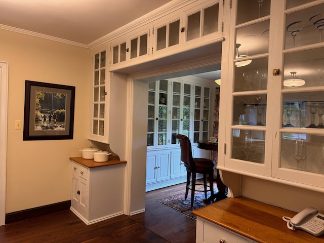 interior space with dark wood-type flooring and ornamental molding