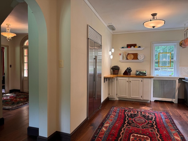 hall featuring crown molding, radiator, and dark wood-type flooring