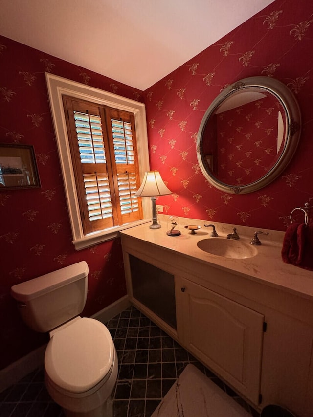 bathroom featuring tile patterned floors, vanity, and toilet