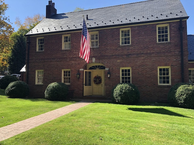 colonial inspired home with a front yard