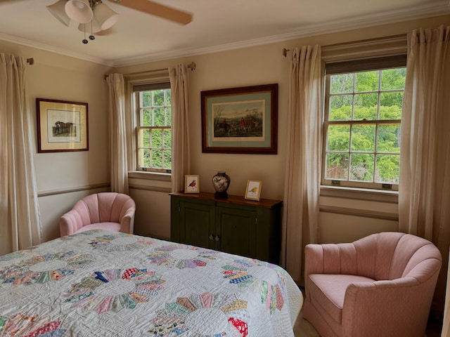 bedroom with ceiling fan, ornamental molding, and multiple windows