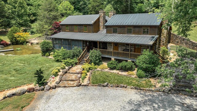 cabin with a front yard and covered porch