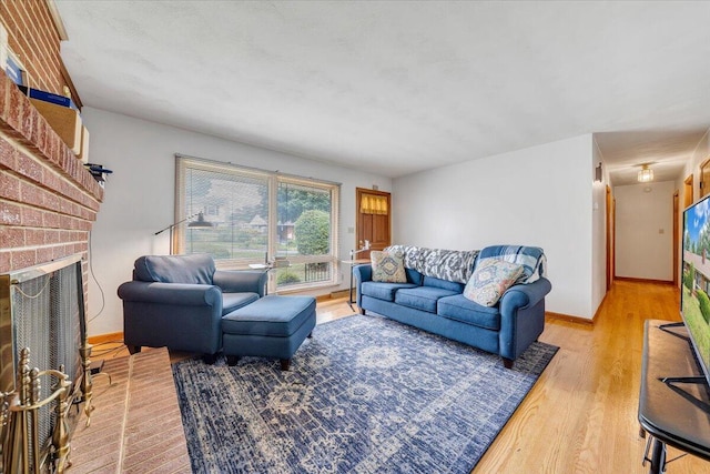 living room featuring a fireplace and light wood-type flooring