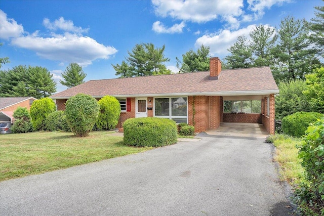 ranch-style home with a carport and a front lawn