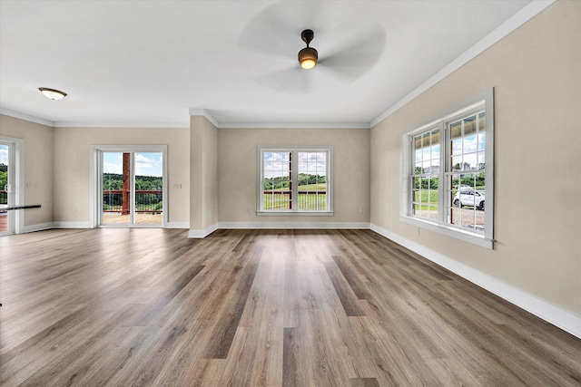 unfurnished living room with crown molding, ceiling fan, and a healthy amount of sunlight