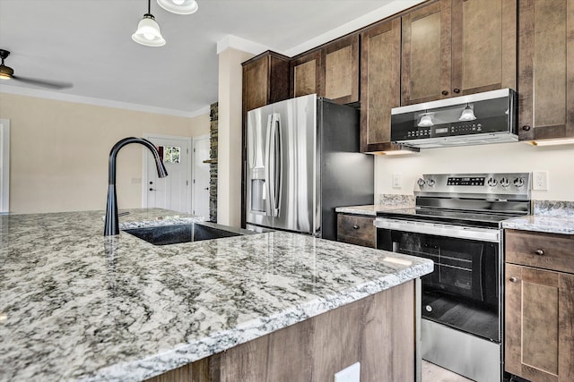 kitchen with sink, light stone counters, dark brown cabinetry, and stainless steel appliances