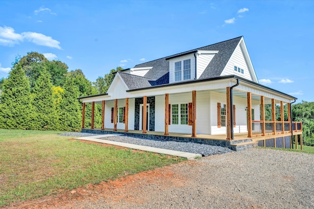 view of front facade with covered porch and a front lawn