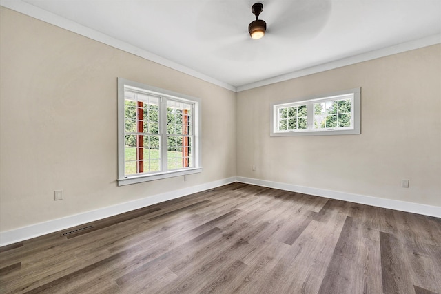 unfurnished room with hardwood / wood-style floors and ornamental molding