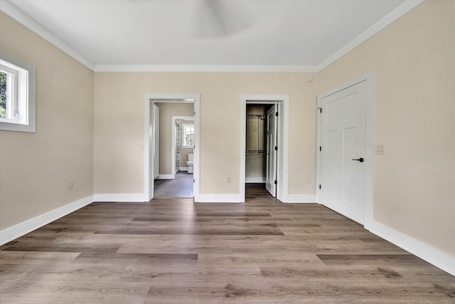 interior space with hardwood / wood-style flooring, ornamental molding, and multiple windows