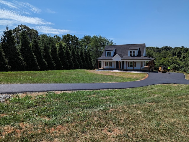 cape cod home featuring a porch and a front lawn