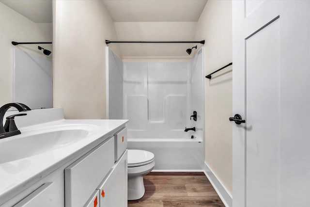 full bathroom featuring hardwood / wood-style floors, vanity, shower / bathtub combination, and toilet