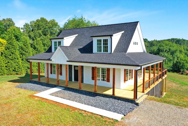 farmhouse-style home with a porch and a front yard