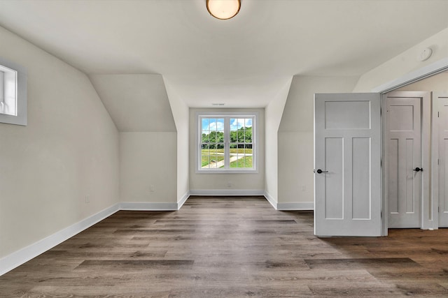 bonus room with hardwood / wood-style floors and lofted ceiling