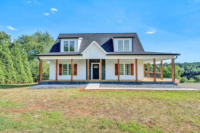 view of front of house featuring covered porch and a front lawn