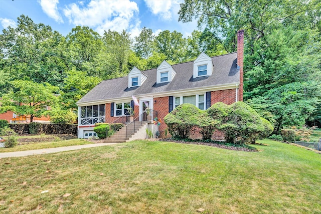 cape cod house featuring a front yard