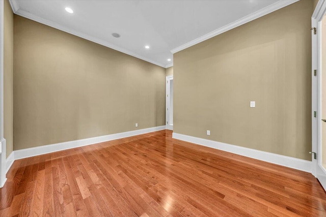 unfurnished room featuring ornamental molding and hardwood / wood-style floors