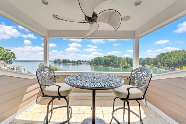 view of patio with a balcony and a water view