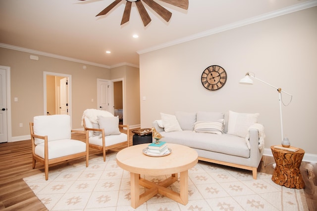 living room with ceiling fan, crown molding, and light hardwood / wood-style flooring