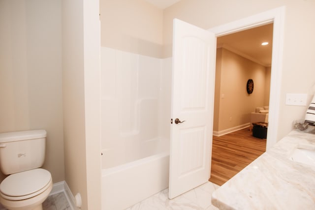 full bathroom featuring washtub / shower combination, vanity, wood-type flooring, and toilet