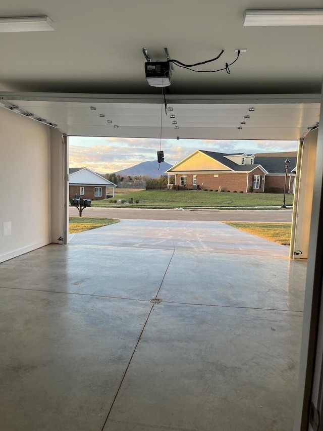 garage with a mountain view and a garage door opener