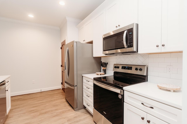 kitchen featuring crown molding, decorative backsplash, appliances with stainless steel finishes, light hardwood / wood-style floors, and white cabinetry