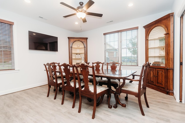 dining area with ceiling fan and light hardwood / wood-style floors