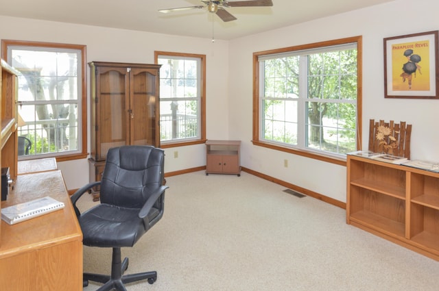 office with carpet floors, baseboards, visible vents, and a ceiling fan