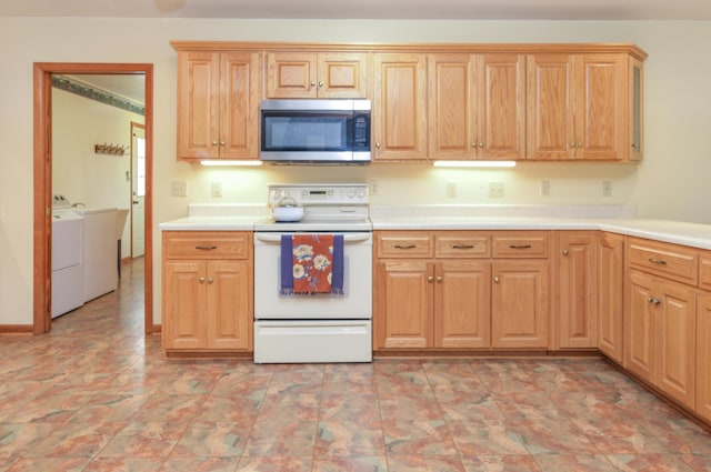 kitchen with light countertops, stainless steel microwave, washing machine and clothes dryer, and white electric range oven