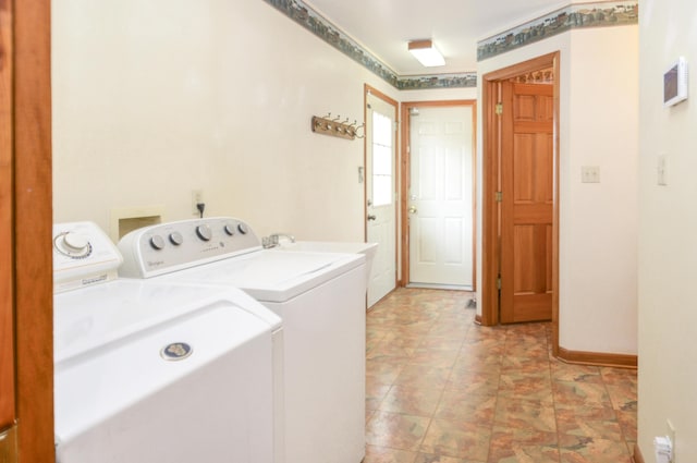 laundry room with baseboards, laundry area, and washer and dryer