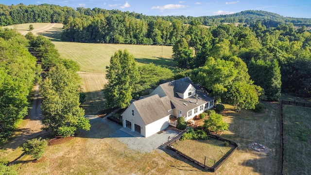 birds eye view of property featuring a forest view and a rural view