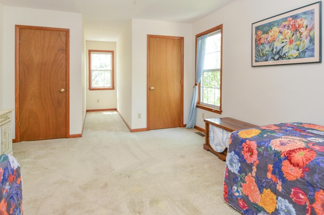 bedroom with carpet, visible vents, and baseboards