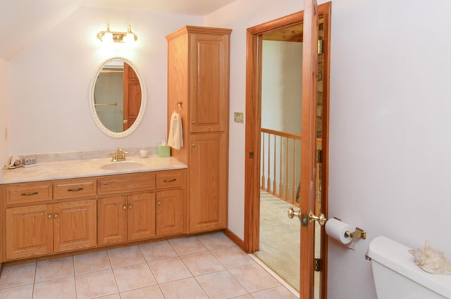 bathroom featuring tile patterned flooring, vanity, and toilet