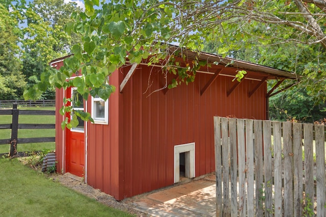 view of outbuilding with an outbuilding and fence