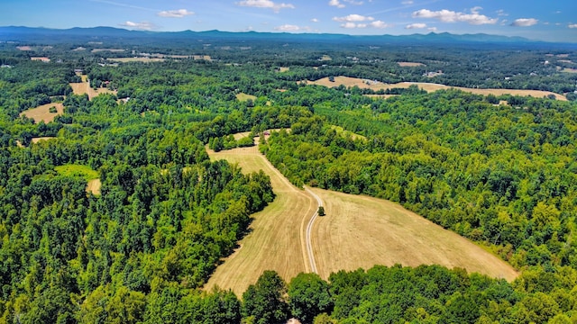 aerial view with a mountain view and a wooded view