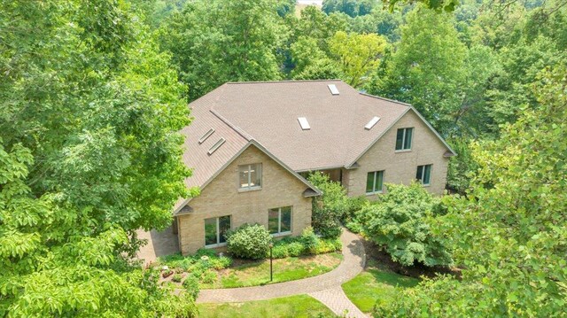 back of house with a yard and a sunroom