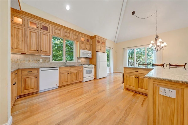 kitchen with decorative backsplash, white appliances, hanging light fixtures, a chandelier, and light hardwood / wood-style flooring