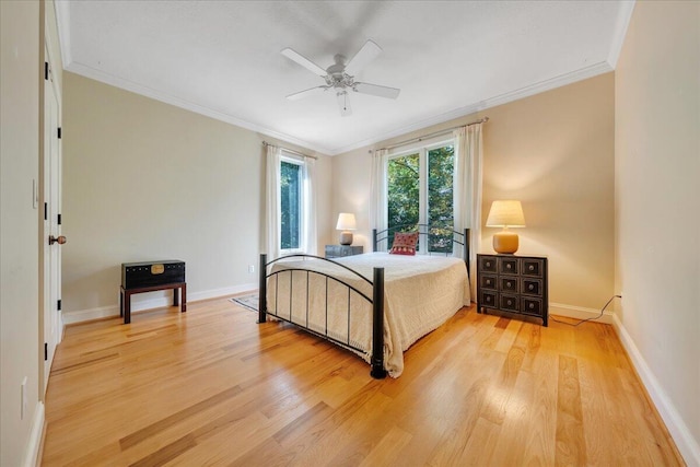 bedroom featuring light hardwood / wood-style floors, ornamental molding, and ceiling fan