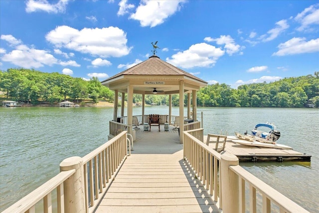 view of dock featuring a gazebo and a water view