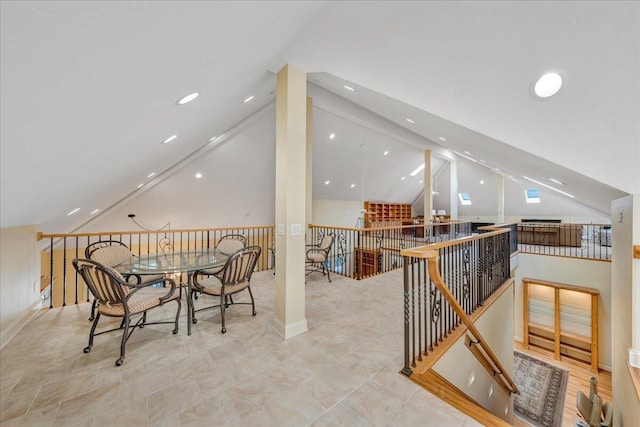 dining space featuring high vaulted ceiling