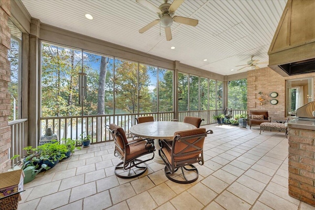 sunroom with ceiling fan and wood ceiling