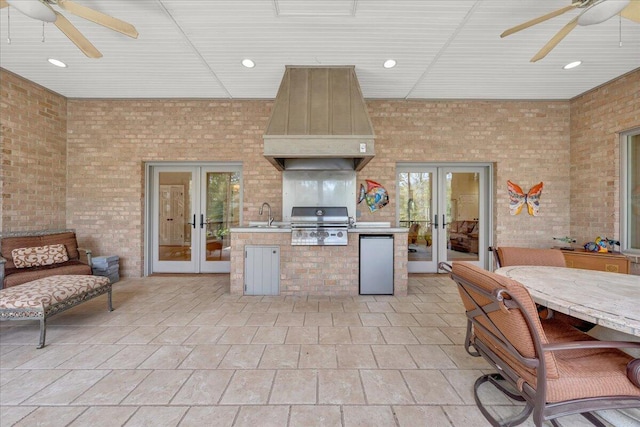 kitchen with french doors, custom exhaust hood, sink, and ceiling fan