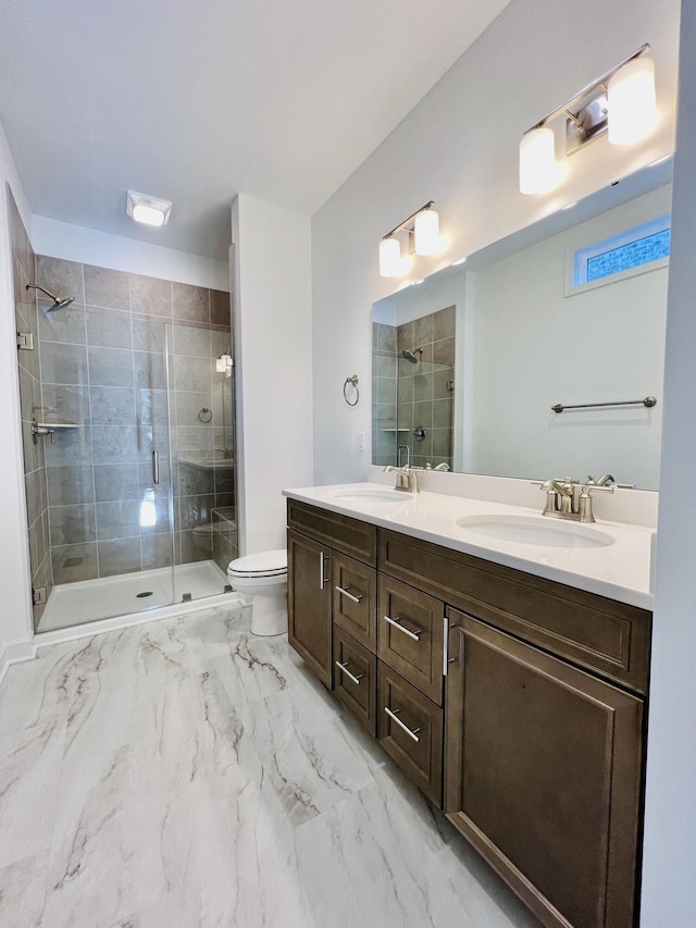 bathroom featuring vanity, toilet, and a shower with door