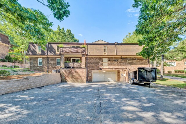 view of front of house featuring a balcony and a garage