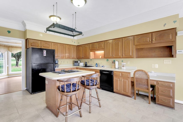 kitchen featuring a kitchen island, light hardwood / wood-style flooring, ornamental molding, and black appliances