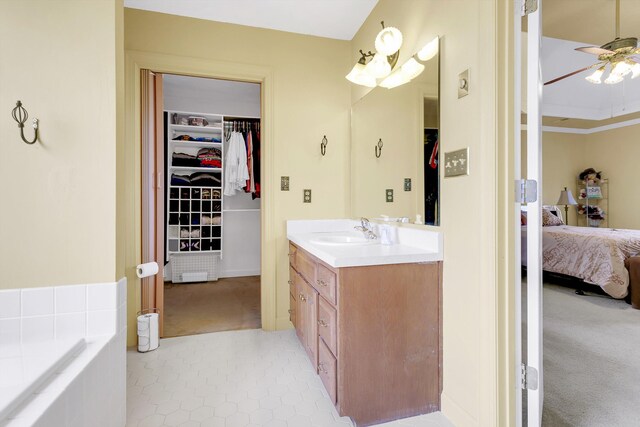 bathroom with ceiling fan, tile patterned flooring, and vanity